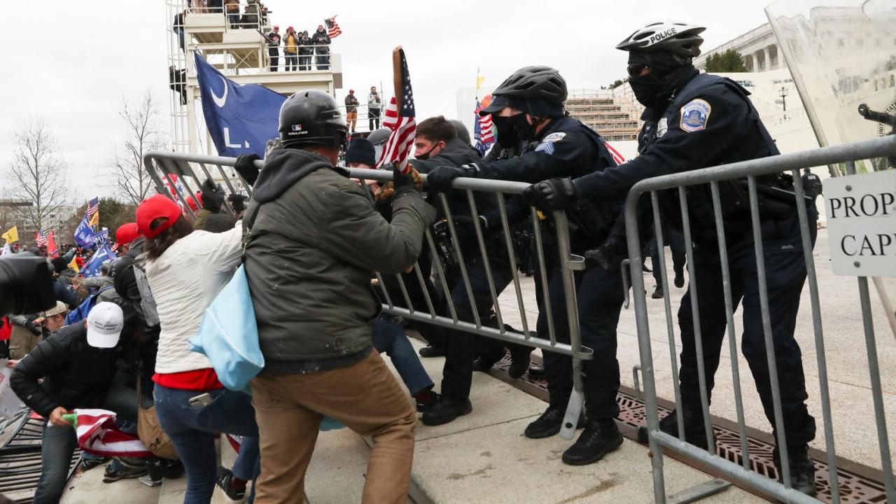 Donald Trump supporters clash with police as they attempt to gain access to the U.S. Capitol building ahead of Joe Biden
