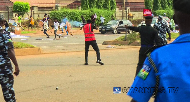 Photo of policeman shooting teargas at June12 protesters in Abuja