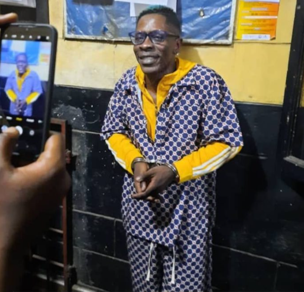 Shatta Wale pictured in handcuffs after he was busted by police over fake shooting incident