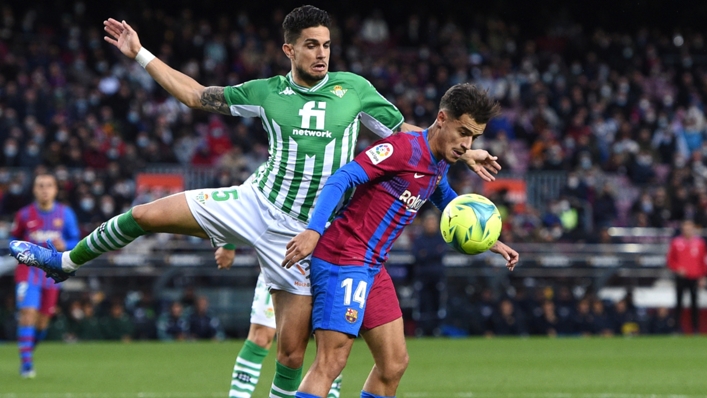 Philippe Coutinho battles for possession with Marc Bartra in Barcelona v Betis