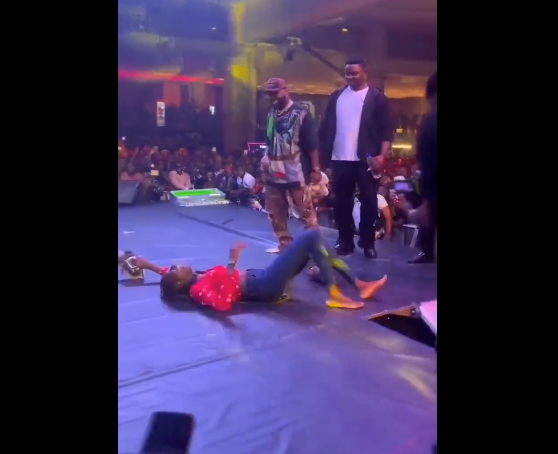 Watch the moment Davido brought out a lucky female fan on stage and gave her his sneakers and N2Million (video)