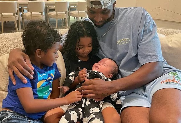 'What about little Theo?': Khloe Kardashian posted this new photo of Tristan Thompson with three of his four children. Thompson gazed adoringly at his newborn son with Khloe while sat beside their daughter True, four, and son Prince, six ¿ the child he shares with ex Jordan Craig